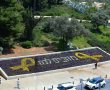 מחכים לכם בבית: מיצב פרחים צהובים בצורת סמל החטופים הוצב מול גן הפעמון